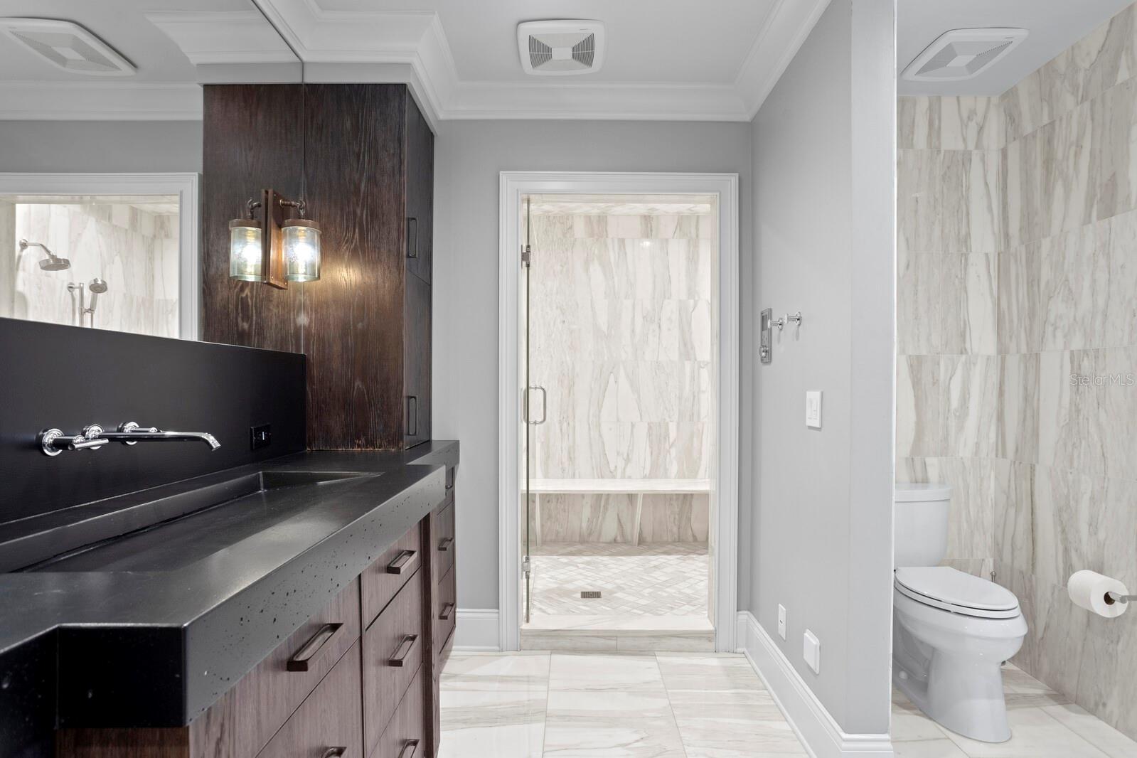 Painted concrete double sinks in primary bathroom.