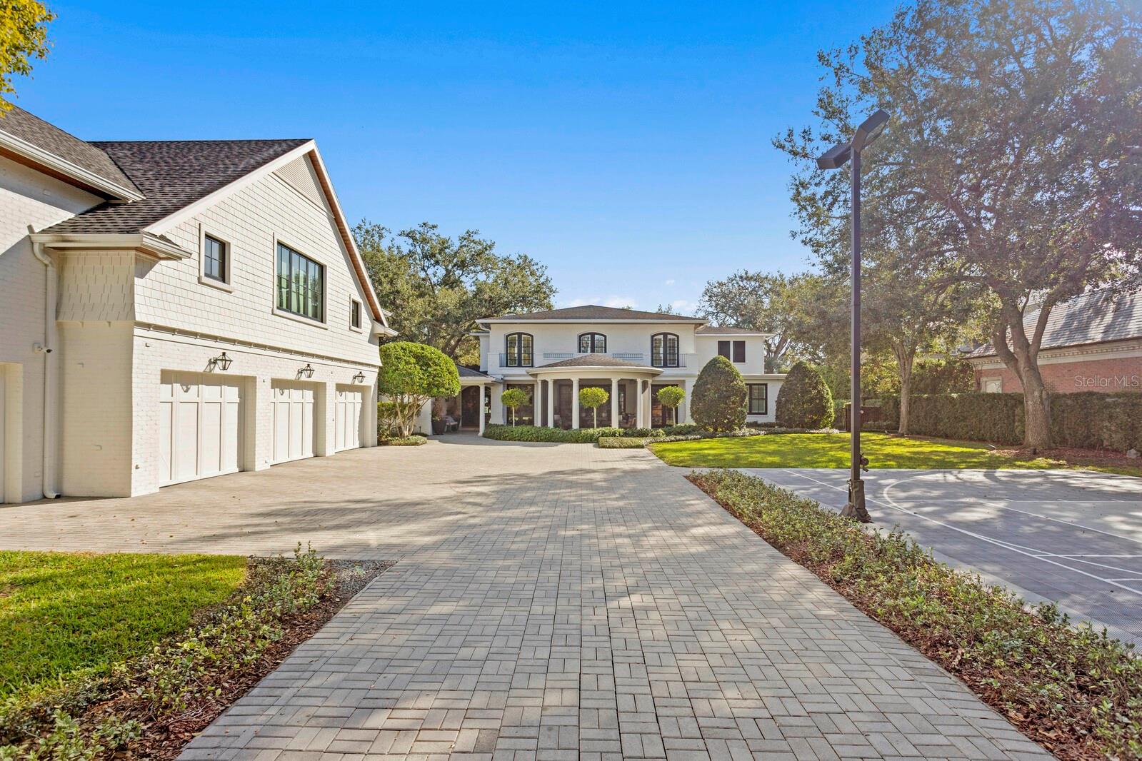 Brick paver driveway, sportcourt, 4 car garage