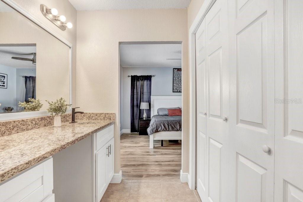 Renovated Primary Bathroom with dual sinks, custom cabinets and granite countertops