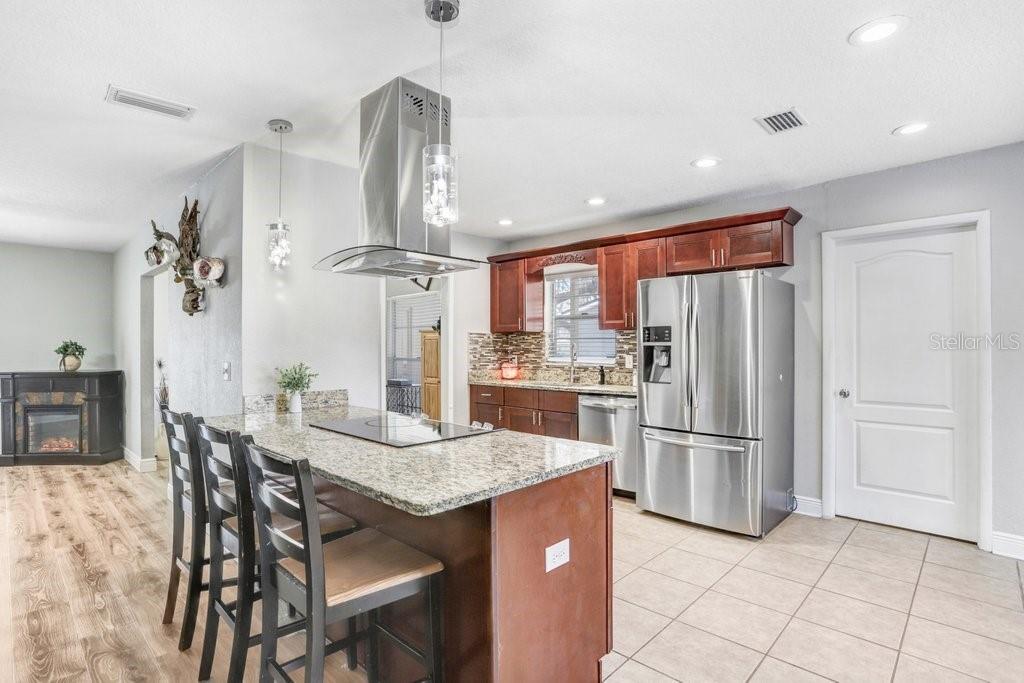 Beautiful renovated kitchen with eating space in kitchen, stainless appliances, cabinets, granite countertops and backsplash