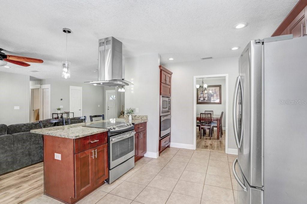 Beautiful renovated kitchen with eating space in kitchen, stainless appliances, cabinets, granite countertops and backsplash