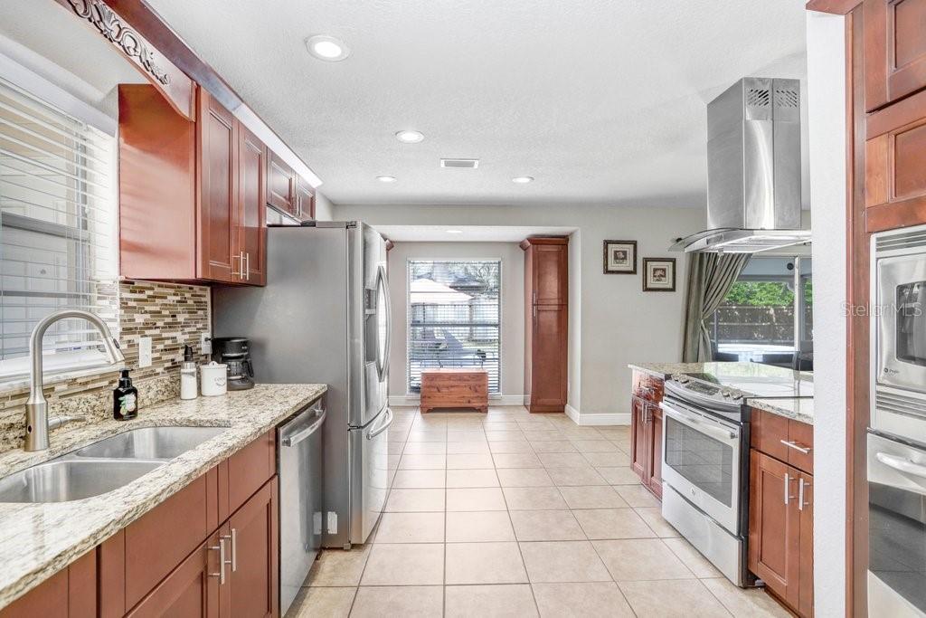 Beautiful renovated kitchen with eating space in kitchen, stainless appliances, cabinets, granite countertops and backsplash