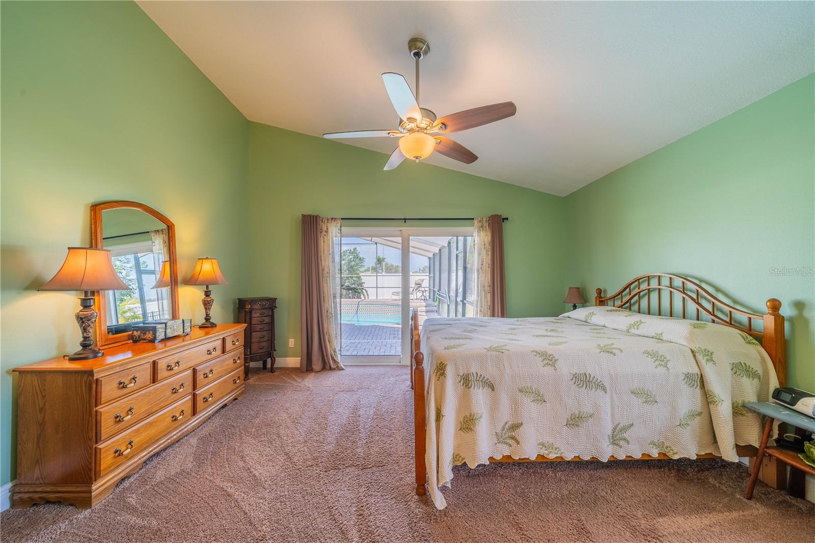 Primary Bedroom with view of pool