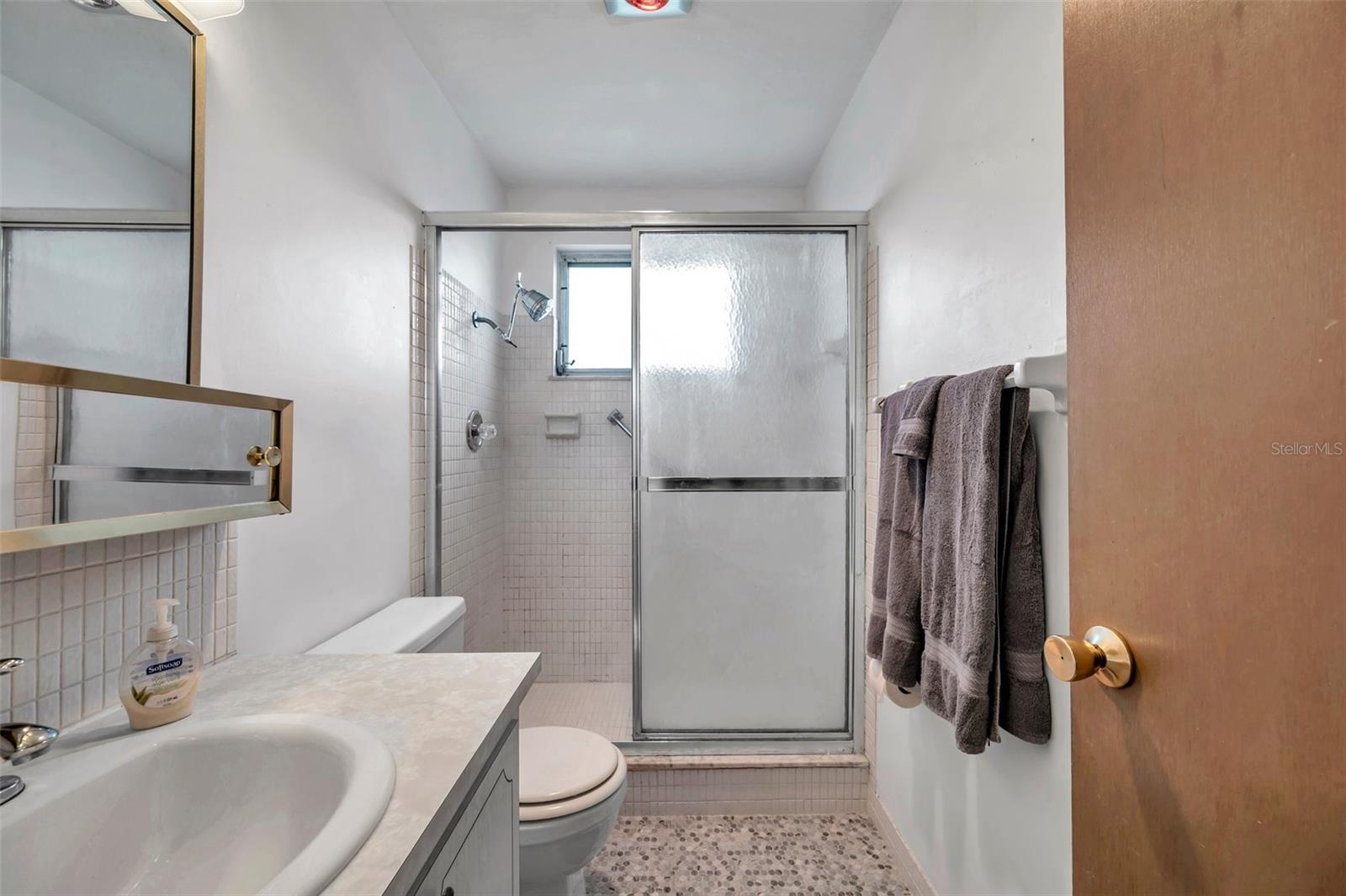 Primary bedroom ensuite with new tile flooring.