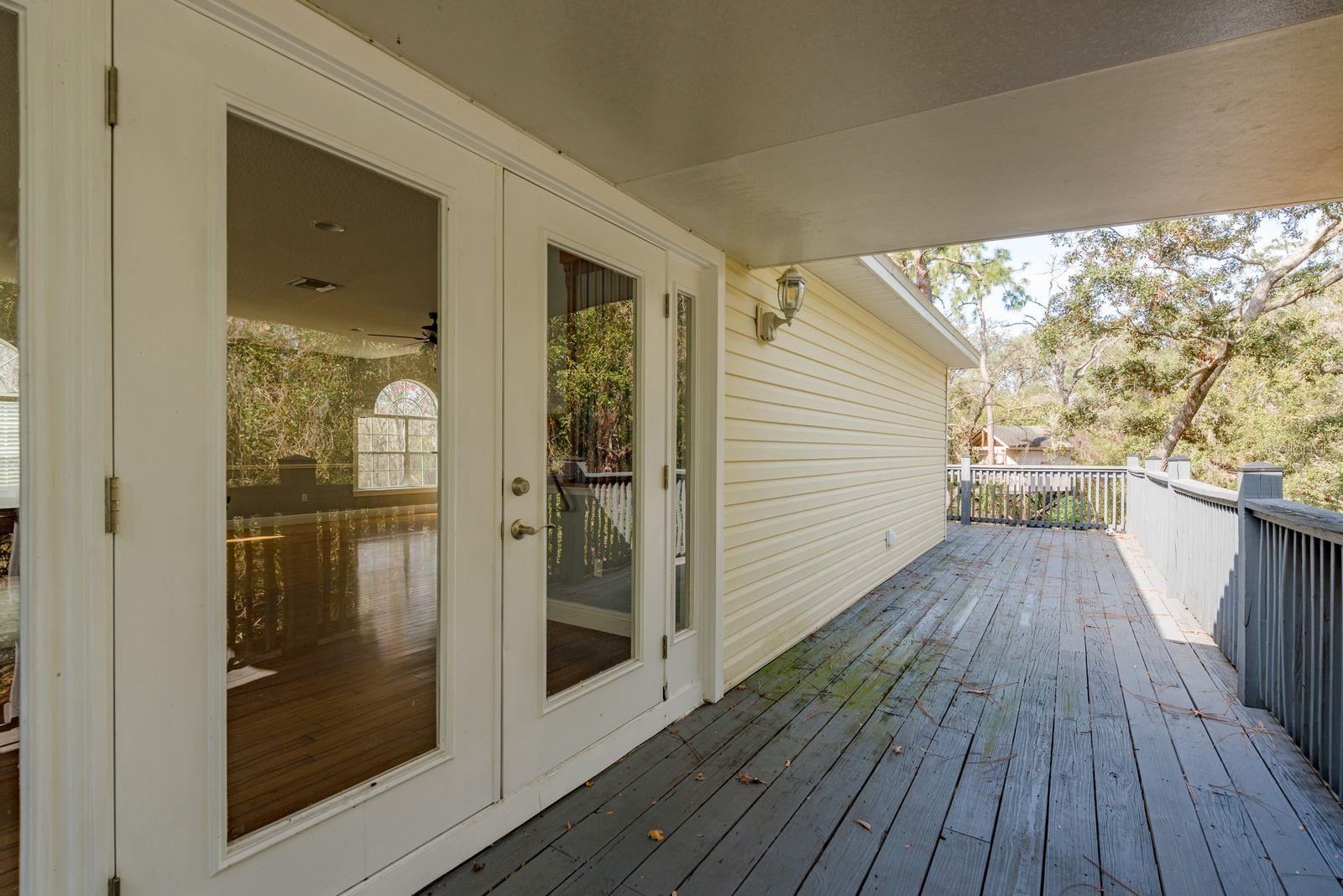 French doors into garage apartment and covered deck.