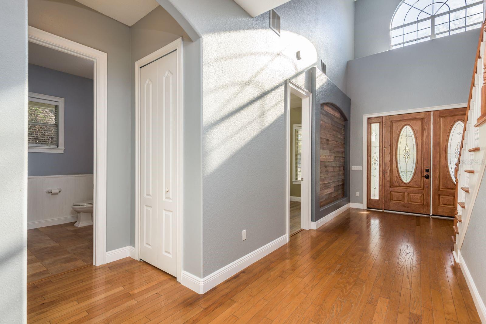 Foyer showing entrance to 1st floor half bathroom and bedroom/office.