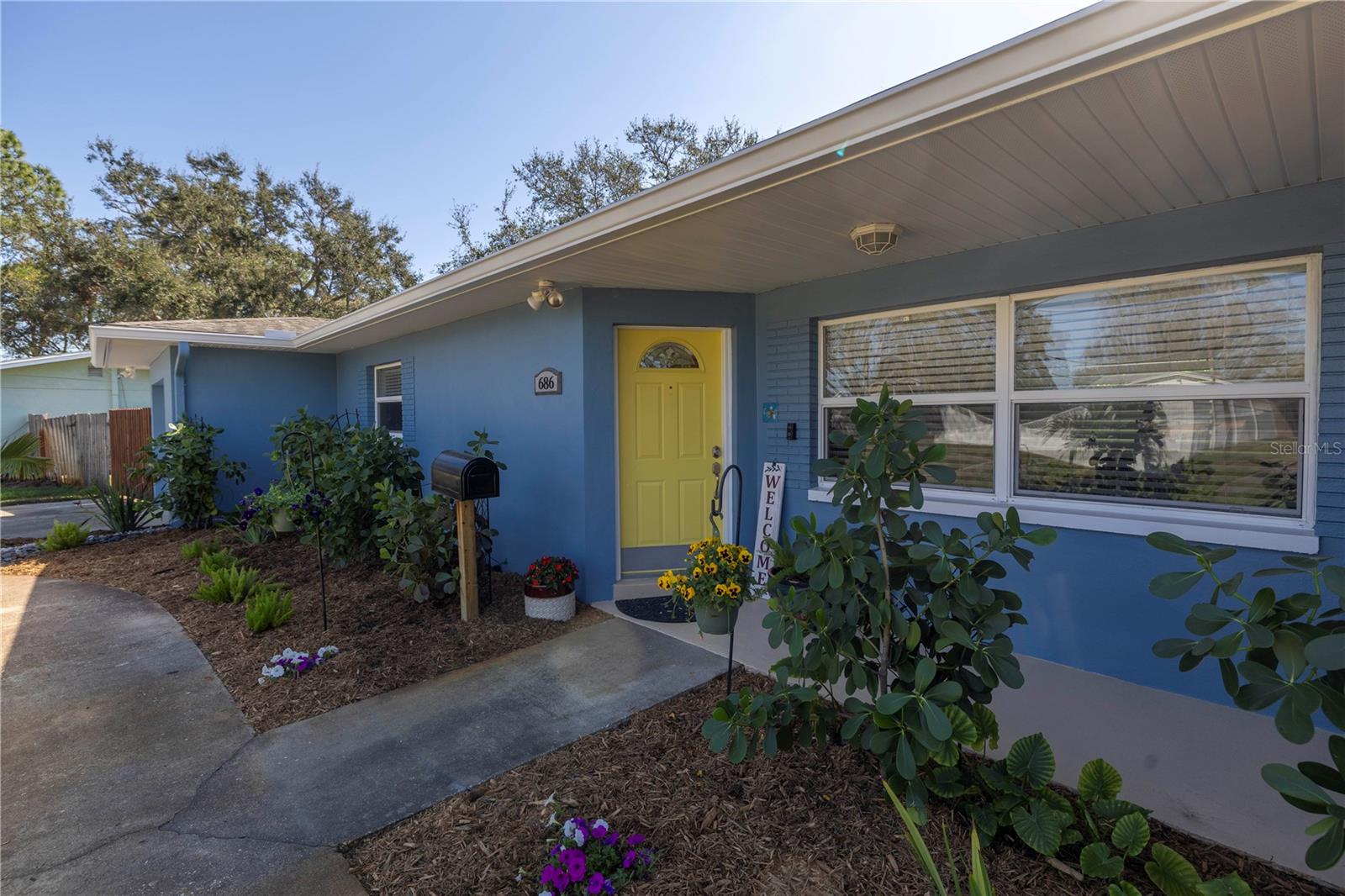 Covered Front Porch and lush landscaped beds for beautiful curb appeal