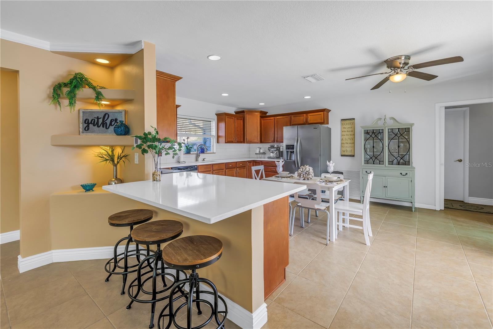 New Quartz counters surround the large Kitchen and top the wood cabinetry