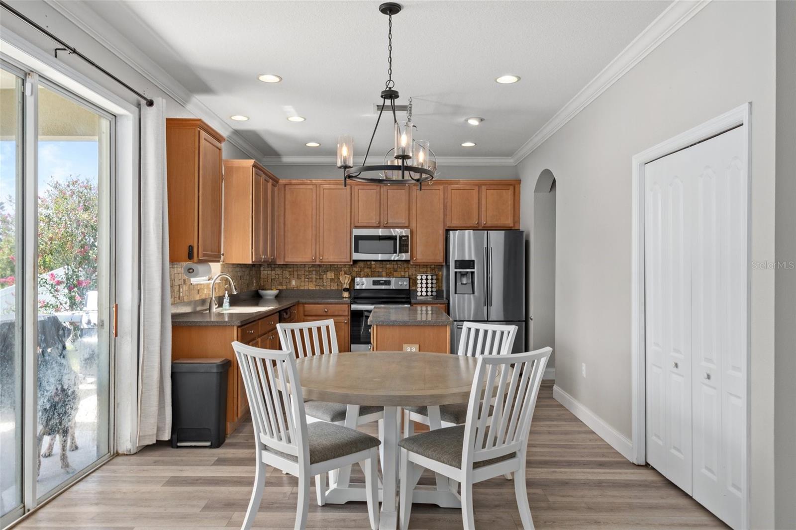 Kitchen Nook Area with NEWER Luxury Flooring, Pantry and Sliders to Lanai