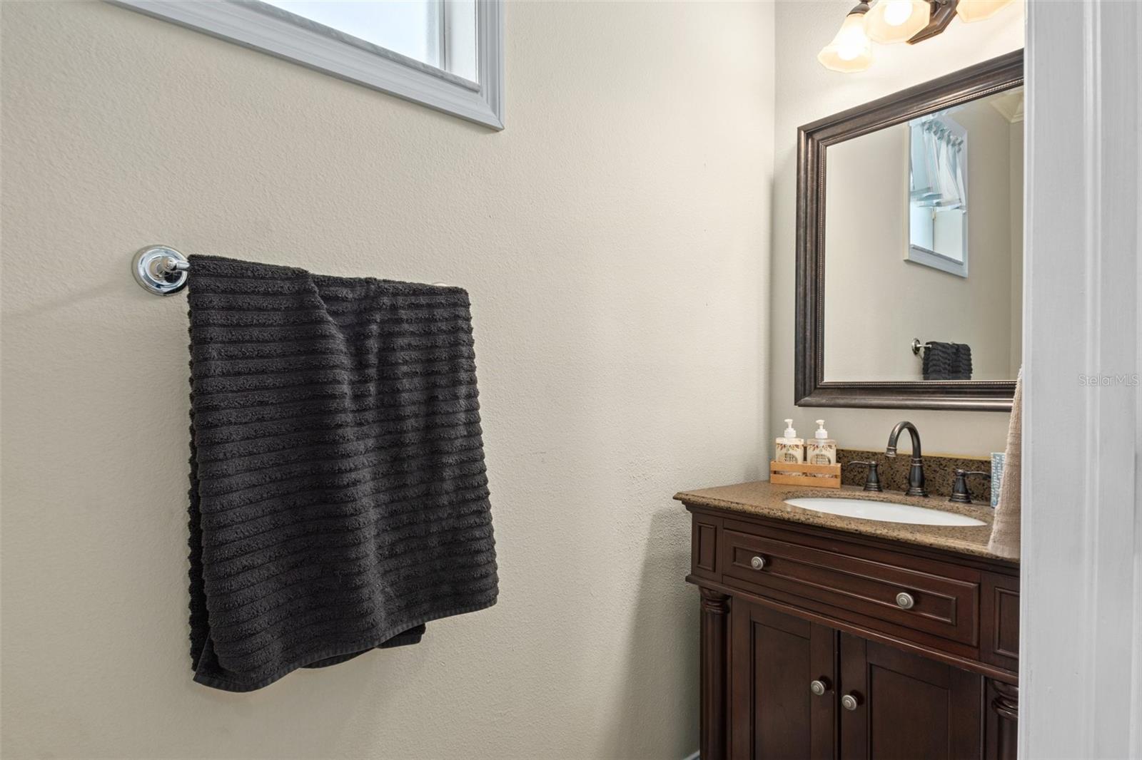 Convenient Downstairs Half Bath with Granite Vanity