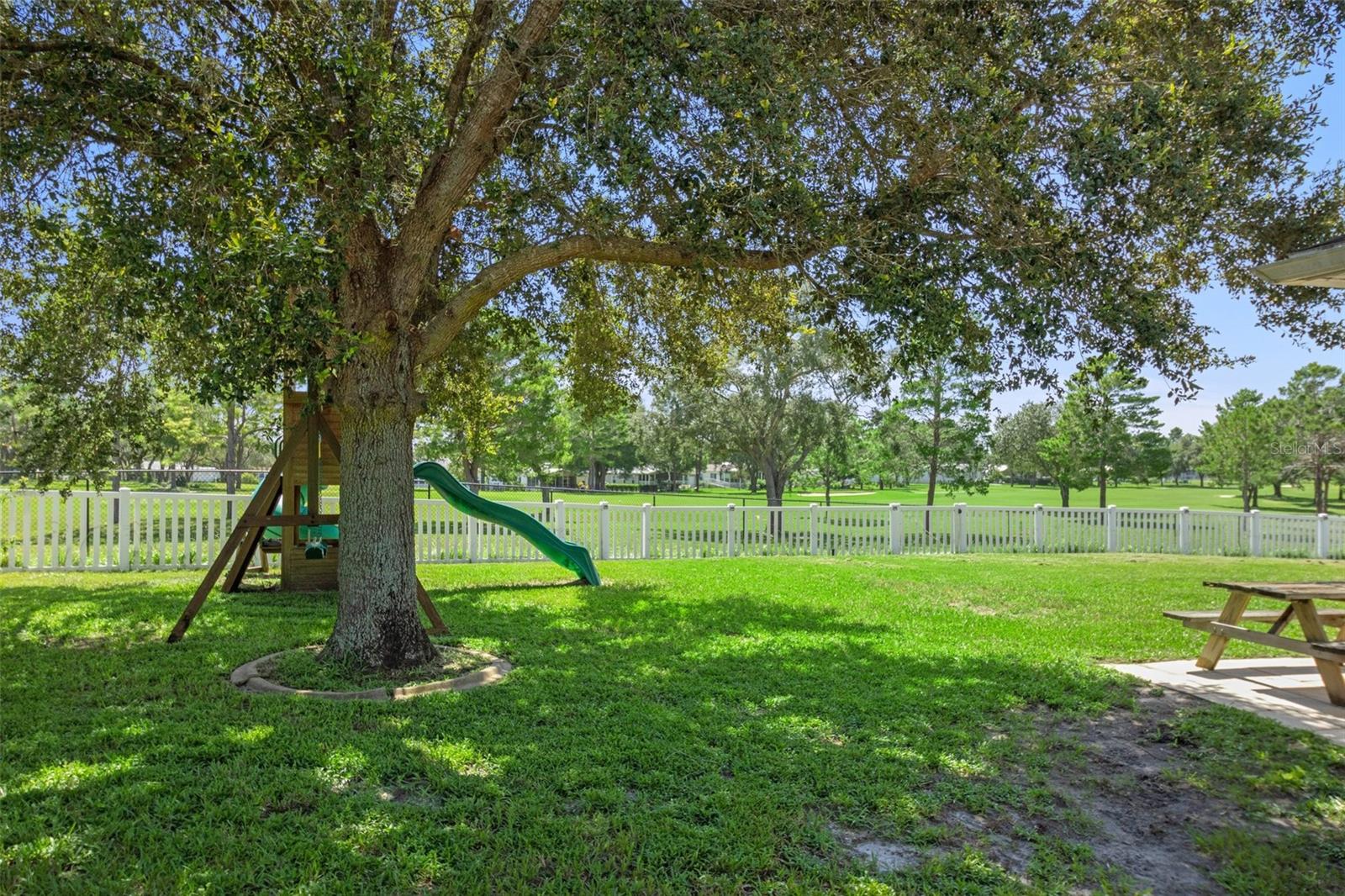 Vinyl Fenced Backyard Overlooking Neighboring Communities Golf Course