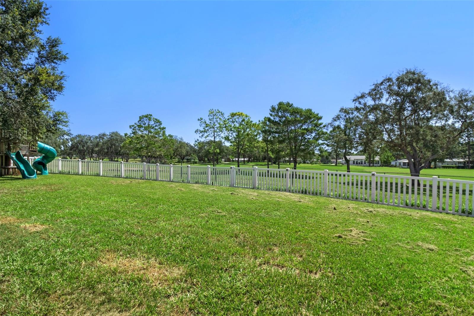 Vinyl Fenced Yard Overlooking Neighboring Communities Golf Course