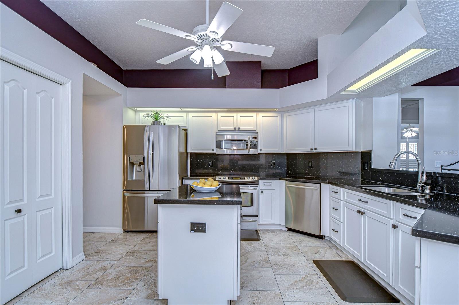 Kitchen is incredibly spacious and features stainless steel appliances.