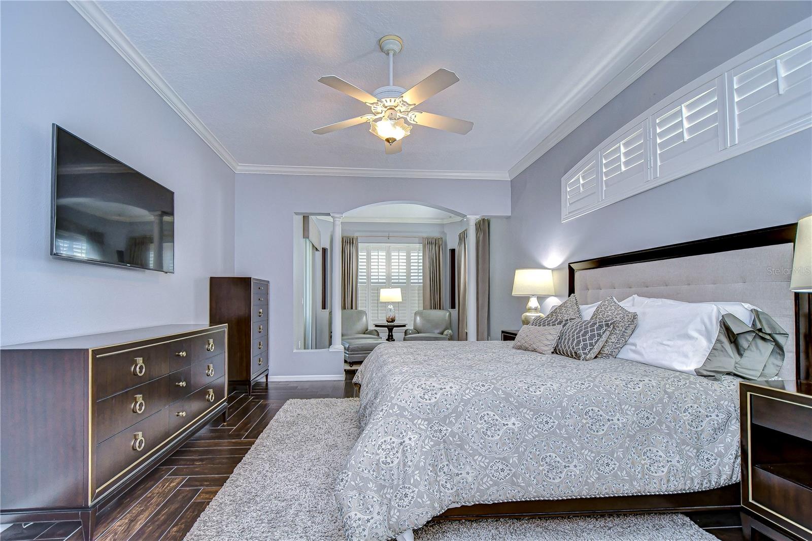 Beautiful spacious primary bedroom appointed with crown molding throughout!