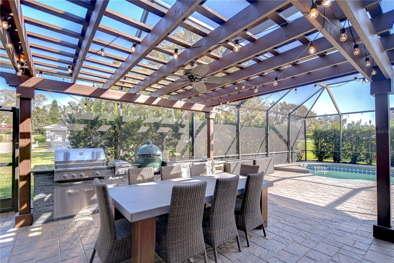 Featuring a gourmet grill, shaded pergola, and sparkling pool, it's the ultimate setting for unforgettable gatherings.