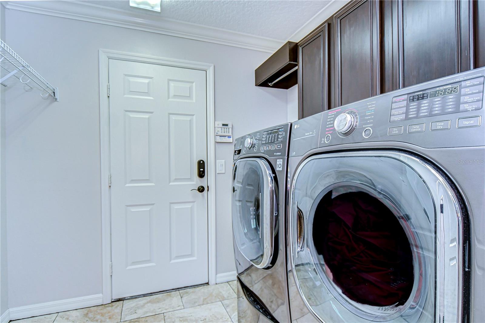 The spacious, well-lit laundry room offers convenience and style, making chore time a breeze.