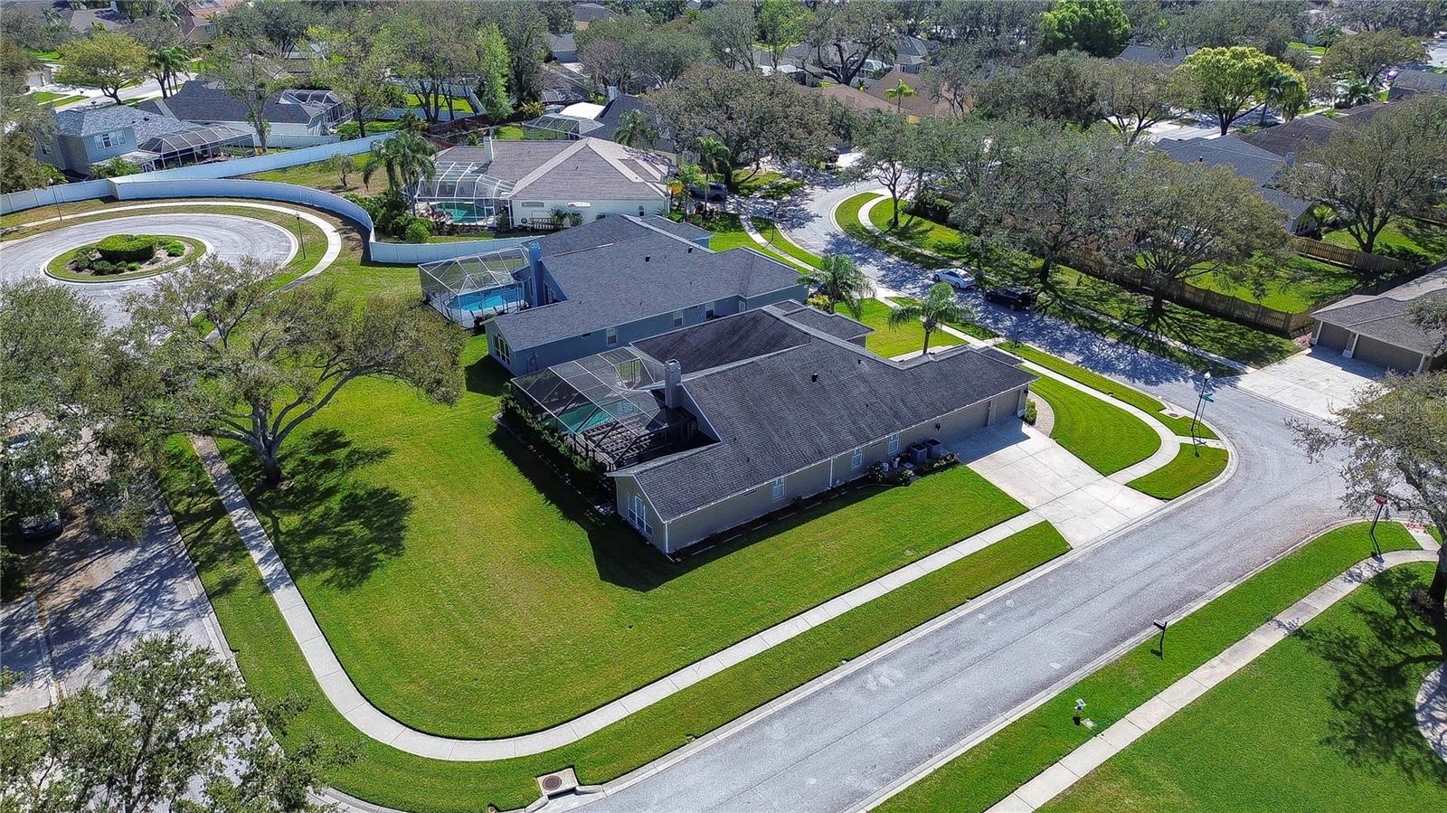 this stunning home offers spacious outdoor living and a sun-drenched pool area.