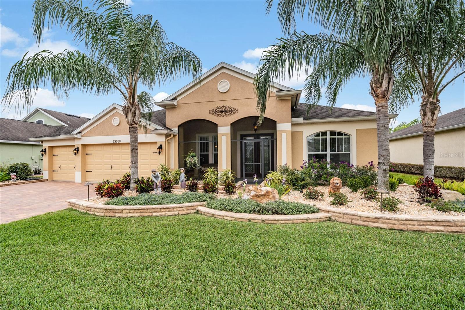 Stunning curb appeal with brick borders and rock accents!