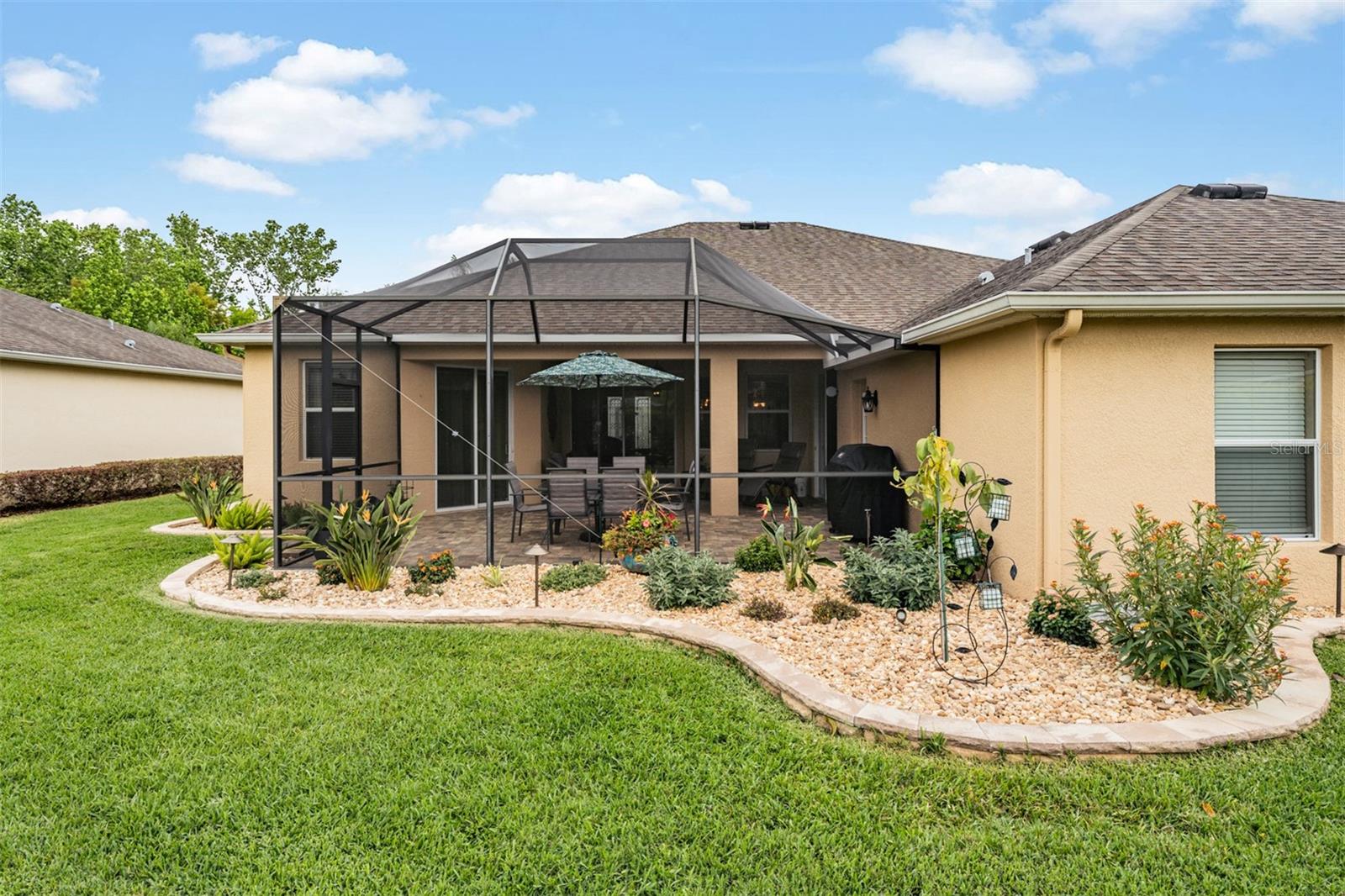 Even the rear has Stunning rock llandscape with concrete curbing!