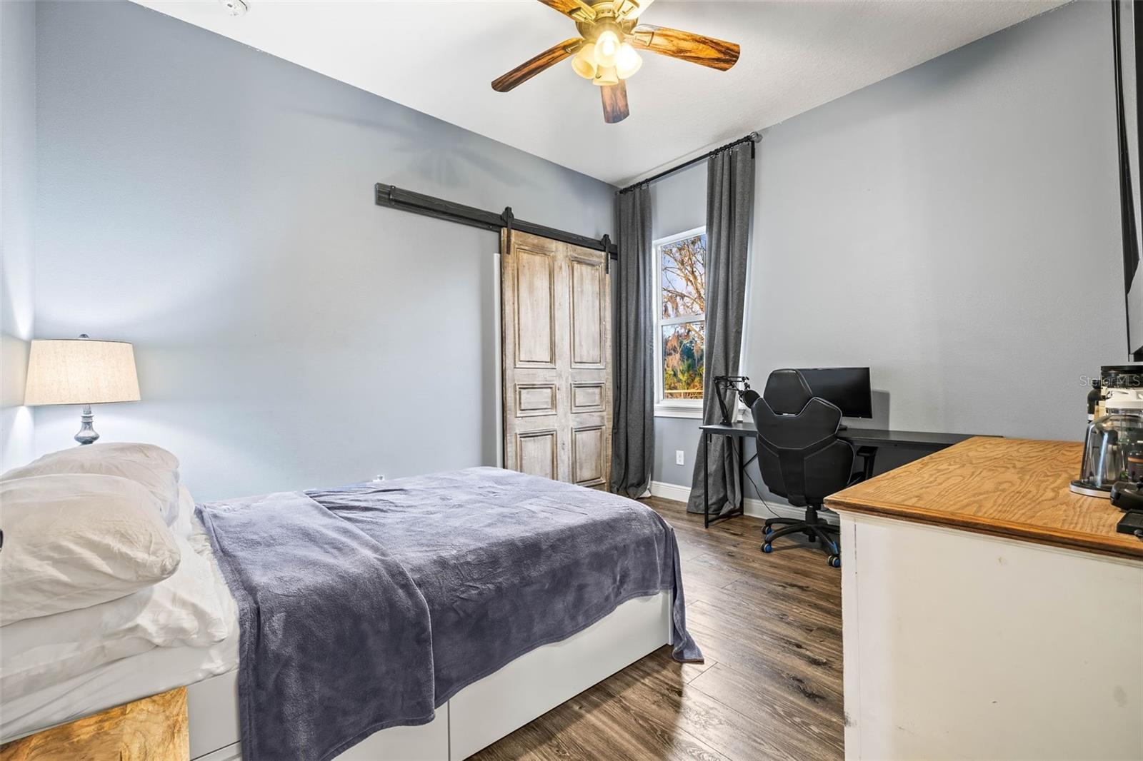 Secondary Bedroom with barn door feature over closet.