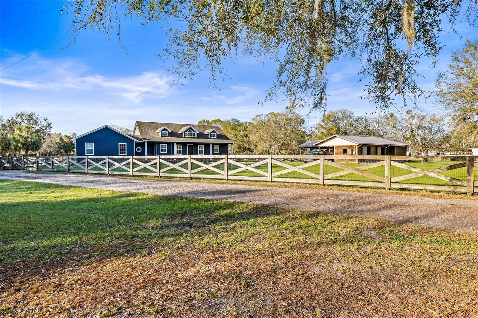 Driveway to house and front pasture with no climb fencing and protective top rail.