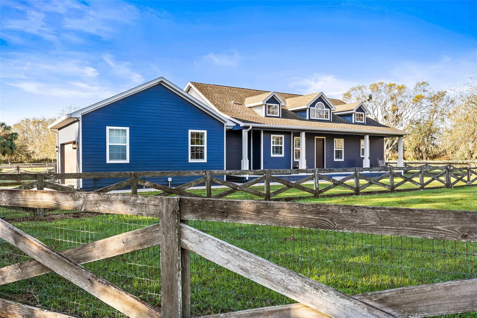 Sodded Front pasture, garage and front elevation.