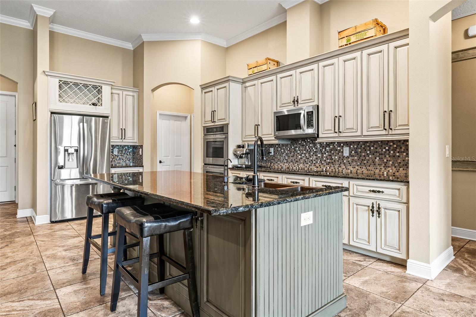 Gourmet kitchen complete with stainless steel appliances including double ovens.