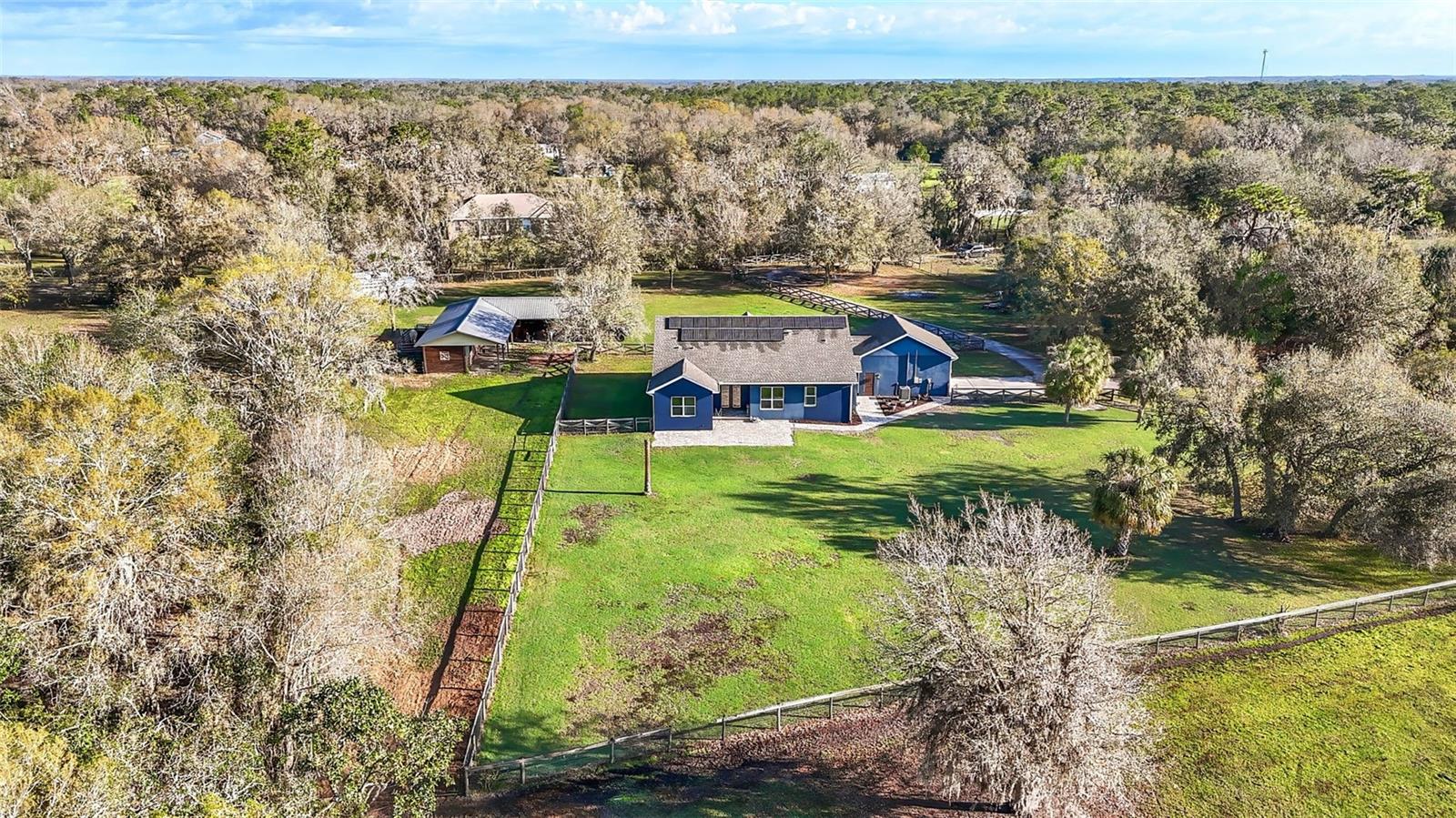 Fence separates the back yard from the back pasture.