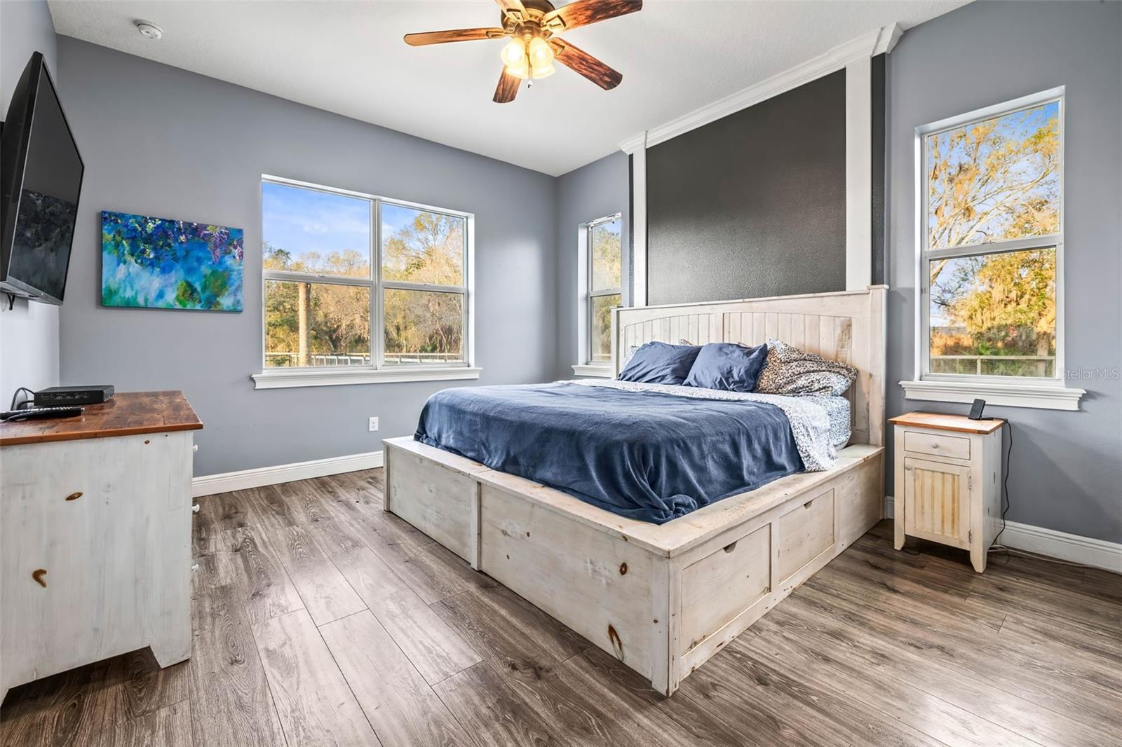 Primary bedroom with decorative accent on wall.