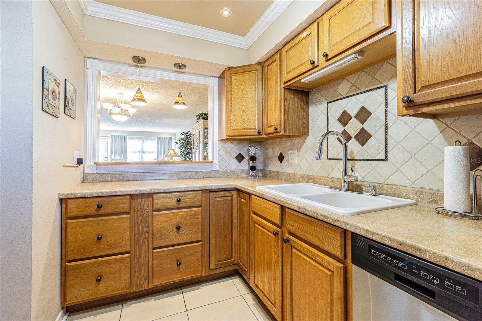 Modern kitchen with wood cabinets and counter tops, plus stainless steel appliances. The kitchen area has a pass-thru with a counter to enjoy your morning coffee.