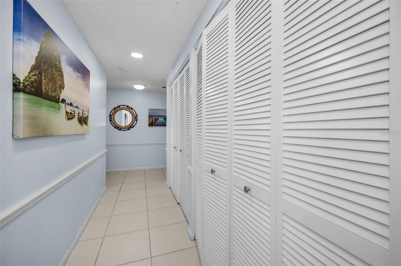 Double and triple closets line the hallways from the entry to the bedrooms.