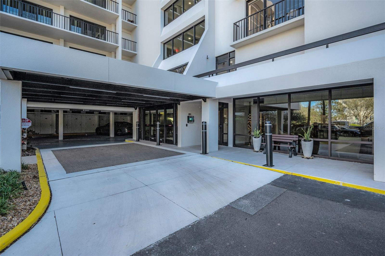 Entry Porte-Cochere and new Fob assisted sliding doors and entry directory.  Fobs work at the back door as well! Not in a flood zone!