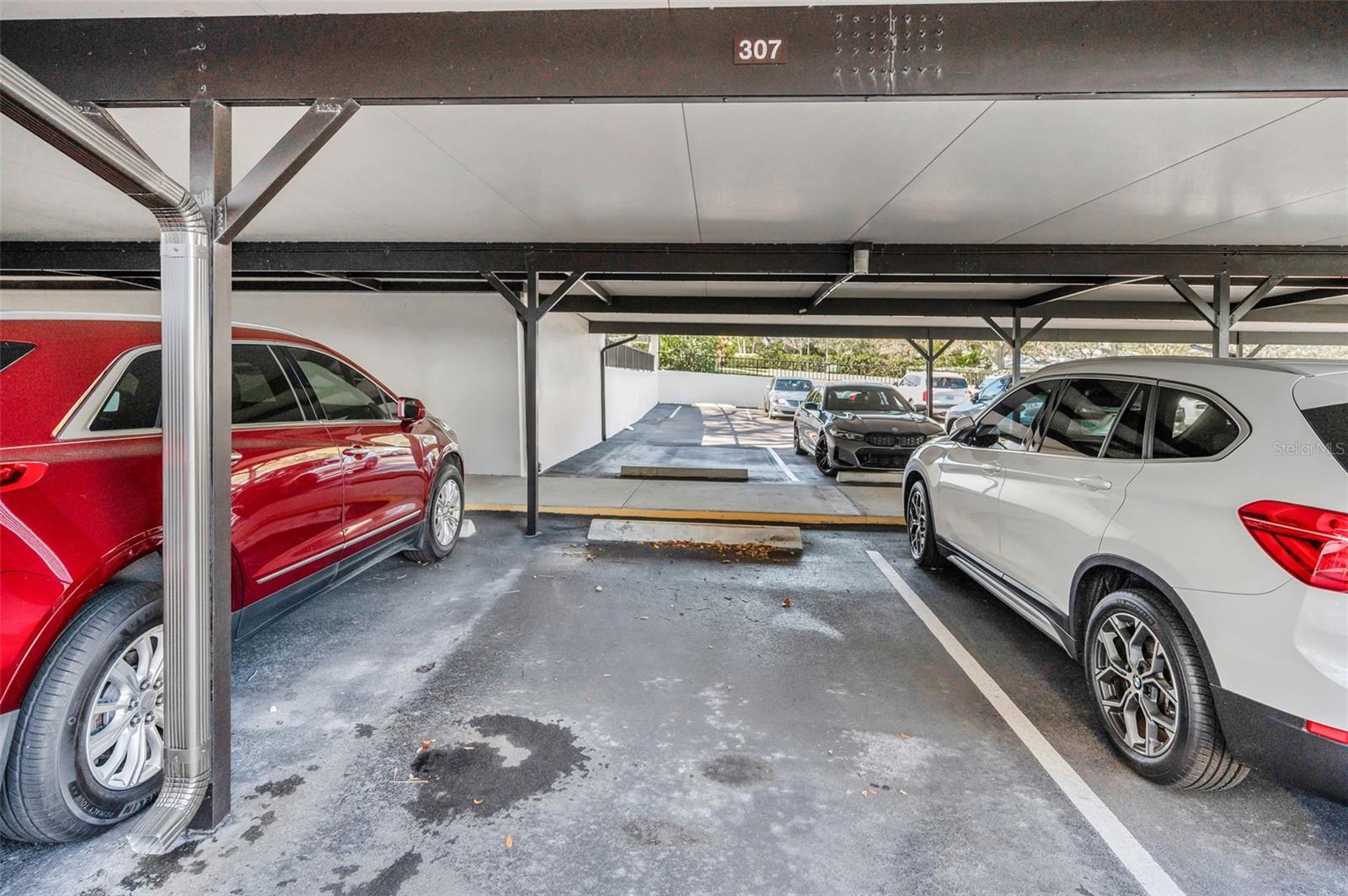 Parking for 307 has a covered walkway to the front door of the building.