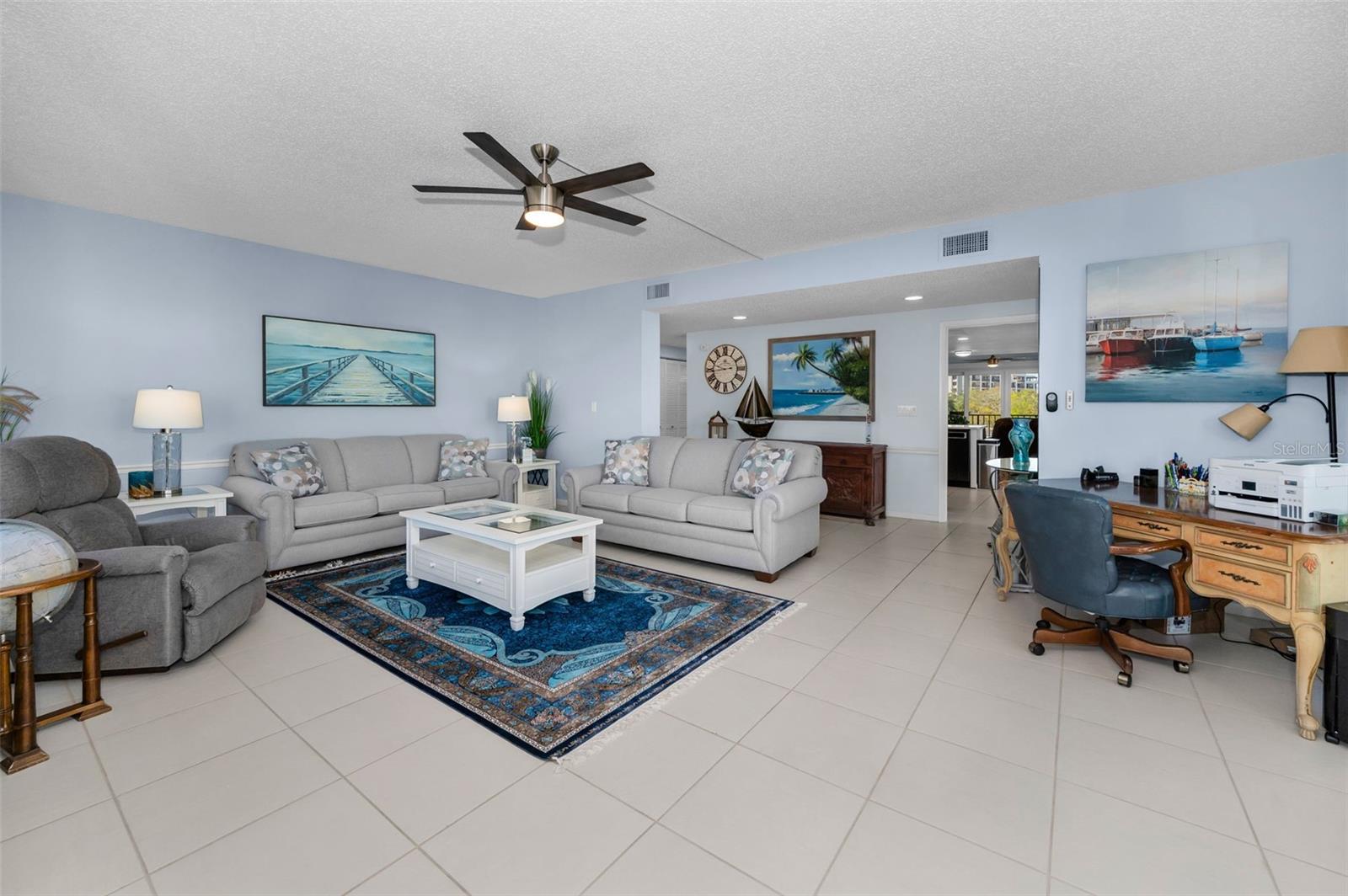 The living room is off the entry foyer and adjacent to the kitchen, which is the heart of the home.