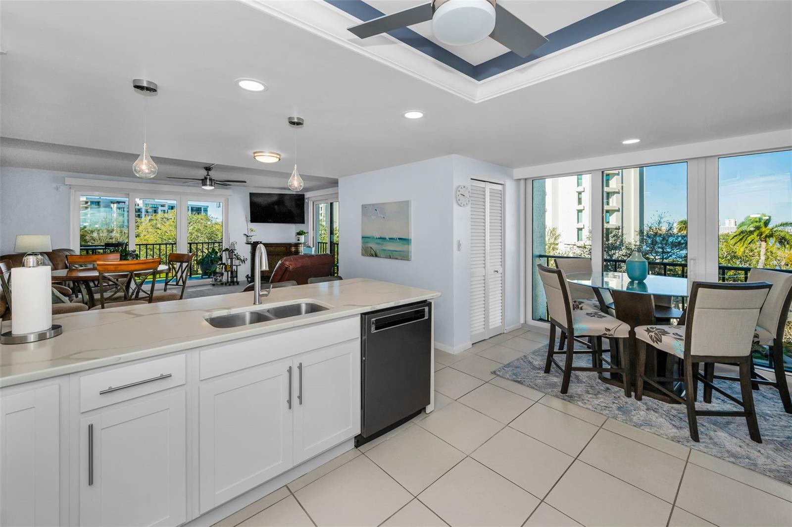 The beautifully updated kitchen opens to the family room with new sliders to the south and the west. Kitchen and has new sliders facing west. Note the walk in Pantry and the walk in laundry room....