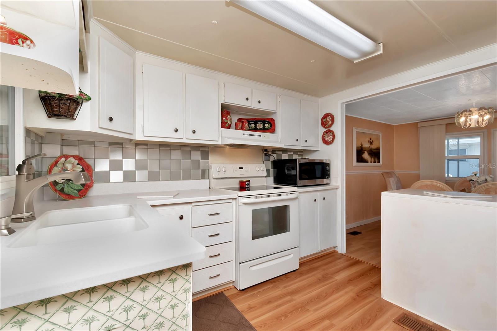 Corian Counters and Solid wood Cabinets open to Dining area