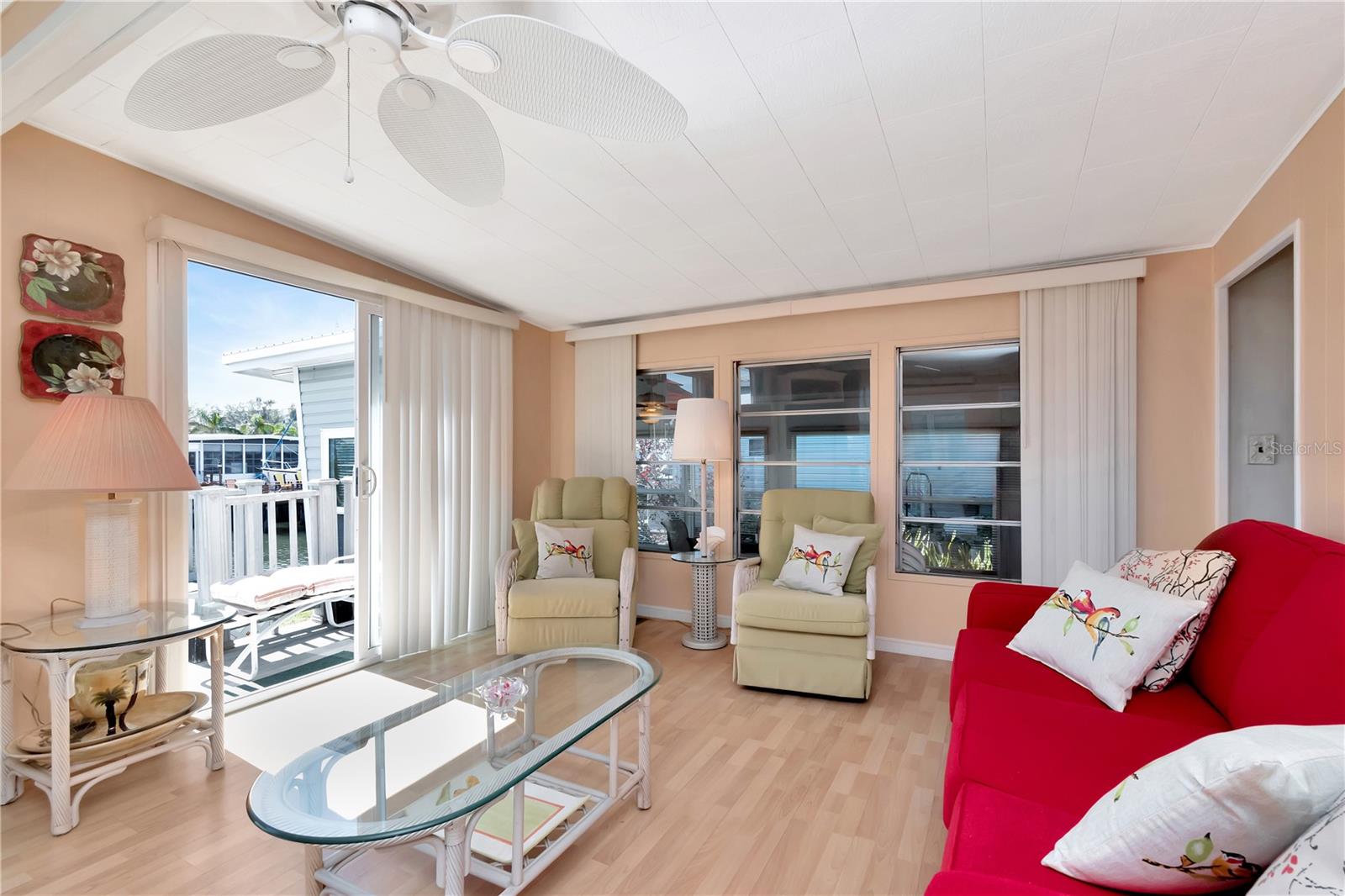 Living / Great Room with beautiful sunrise with amazing water views and oversized sliding doors to your private deck.