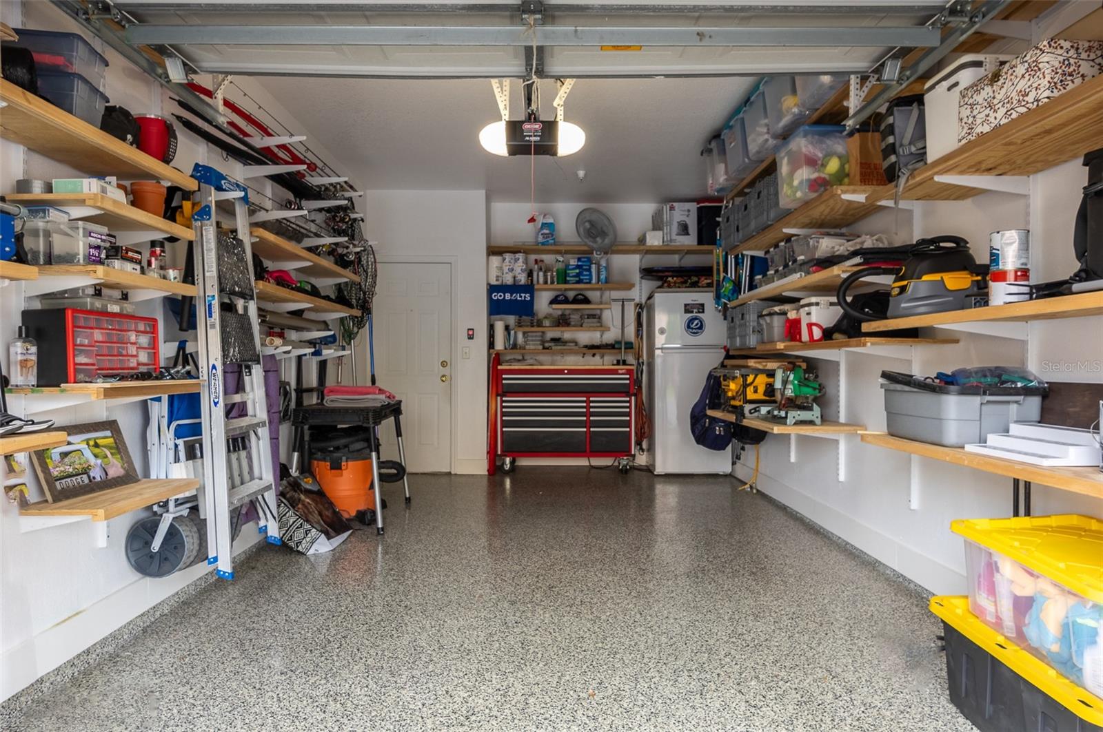 Interior of Garage with New Door opener, Security Pad, Shelving and Finished Floor