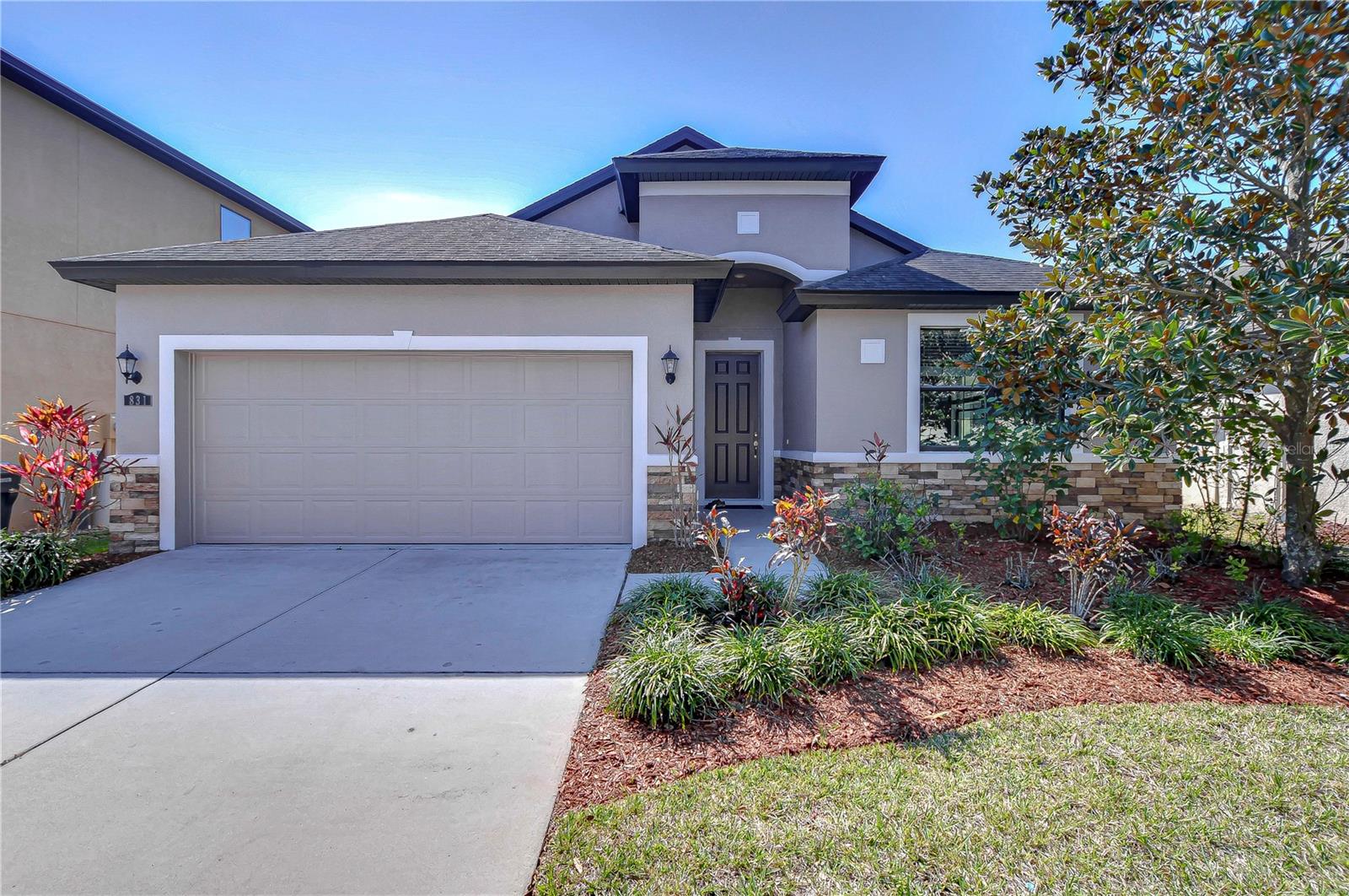 Beautiful home with inviting natural landscaping.