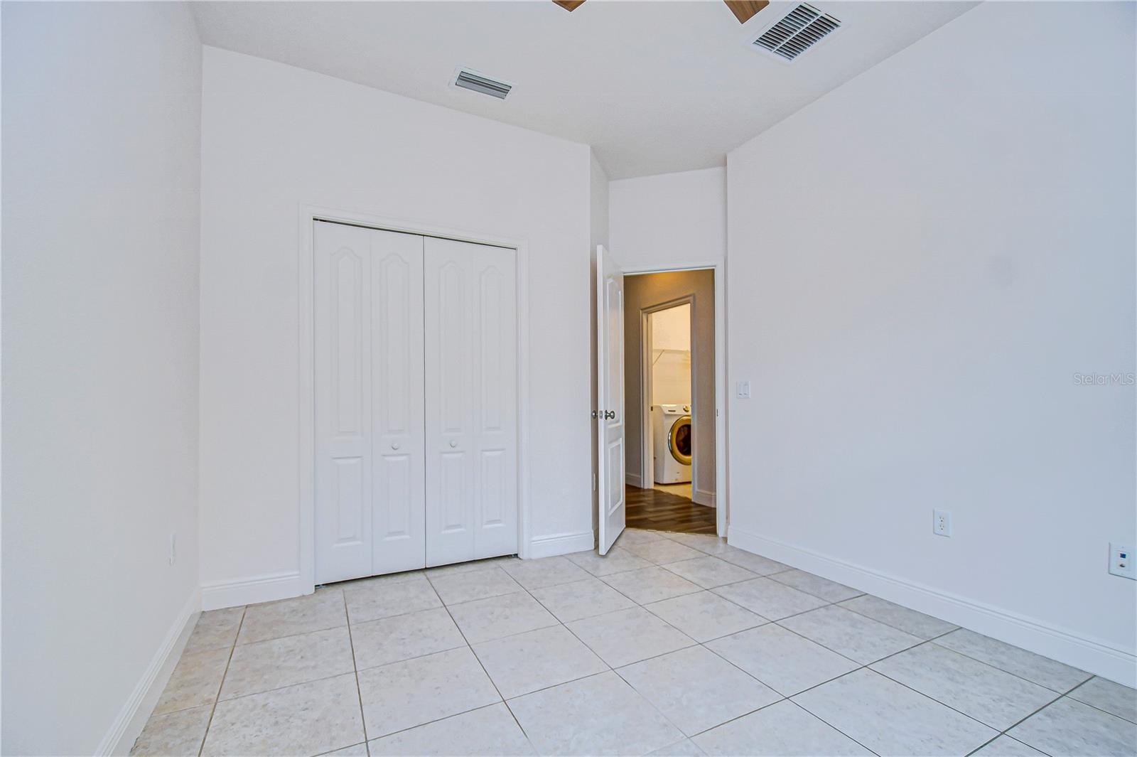 second bedroom with tile floors.