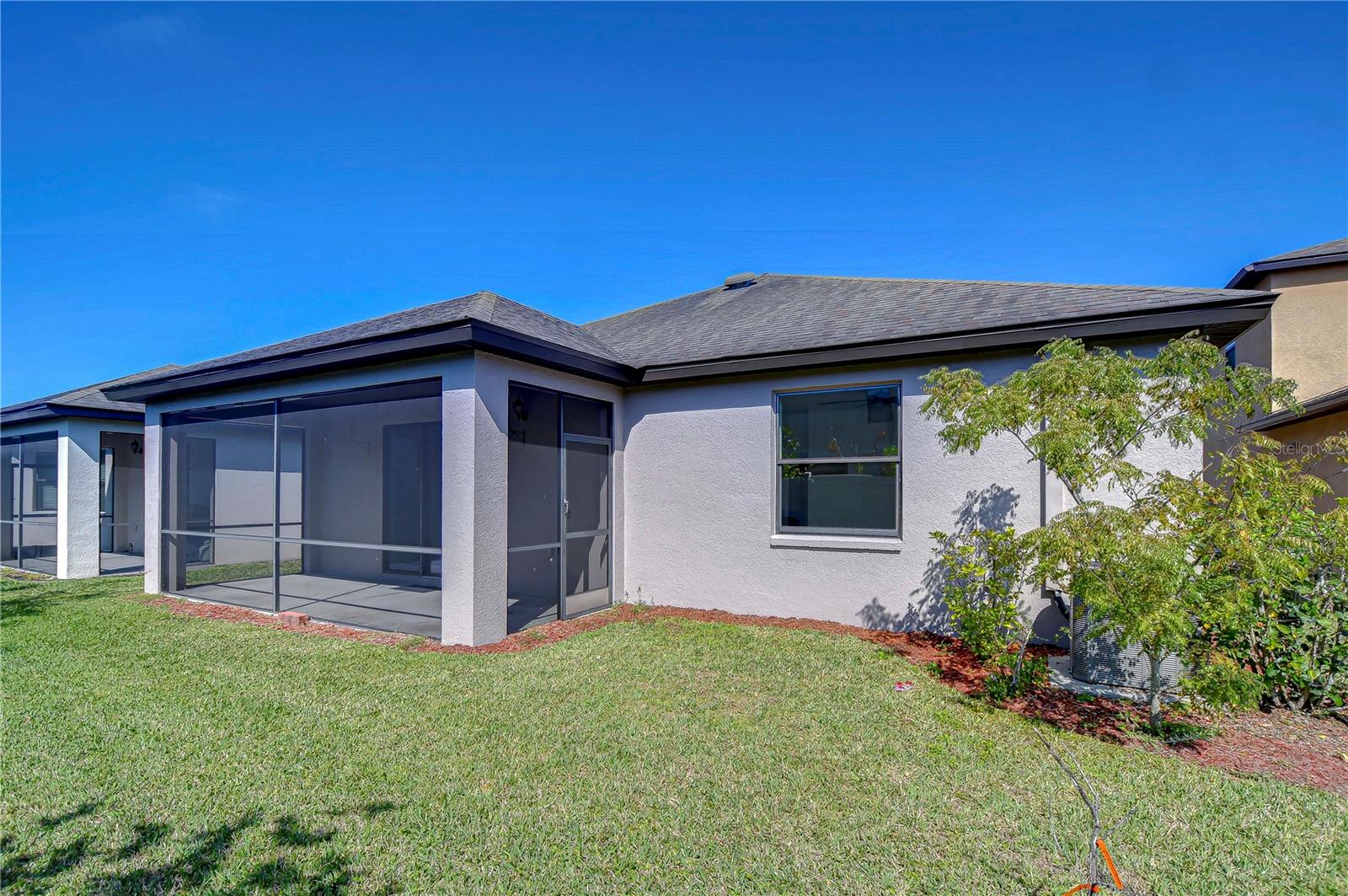 A cozy backyard retreat with a screened-in patio for endless relaxation and outdoor enjoyment!