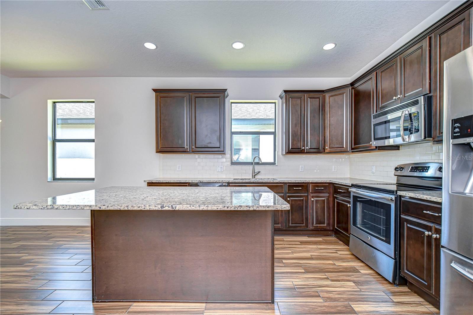 Elegant kitchen with granite countertops and stainless appliances, ready for your culinary creations!