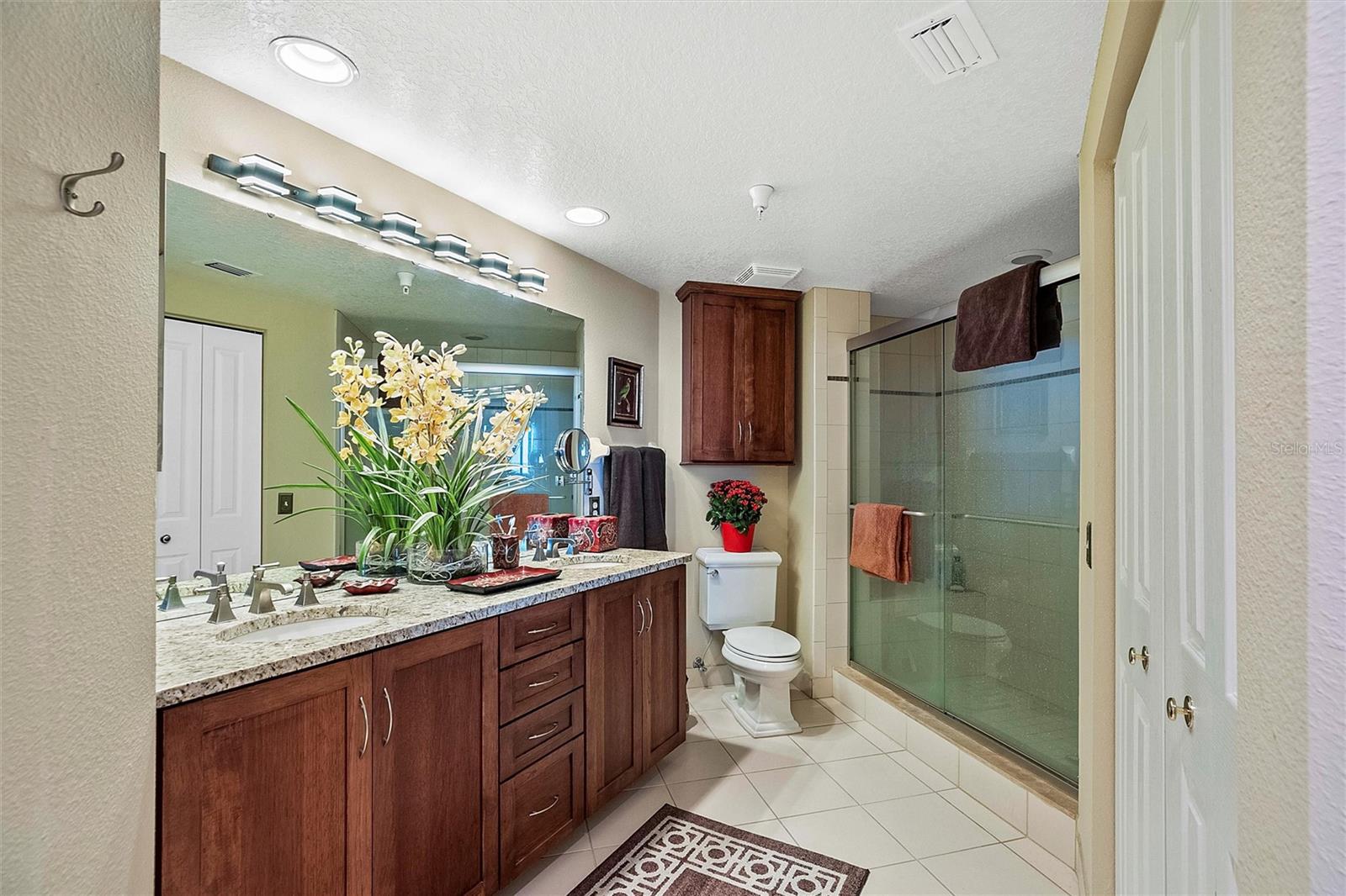 Master bath with his and her closets