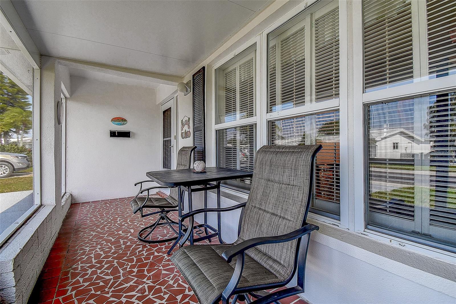 Screened in front porch for enjoying peaceful mornings and evenings