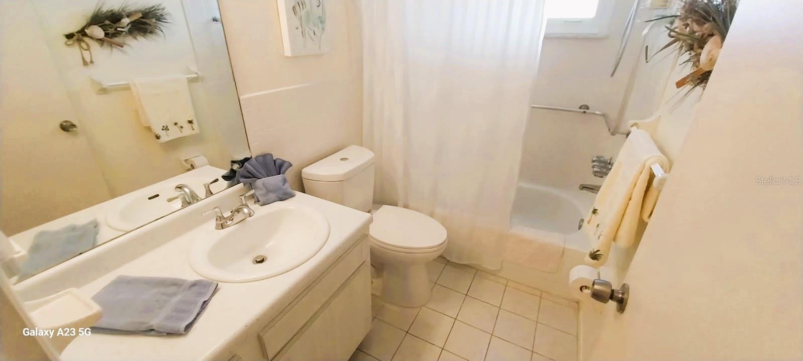 Bathroom has full size tub and shower combo