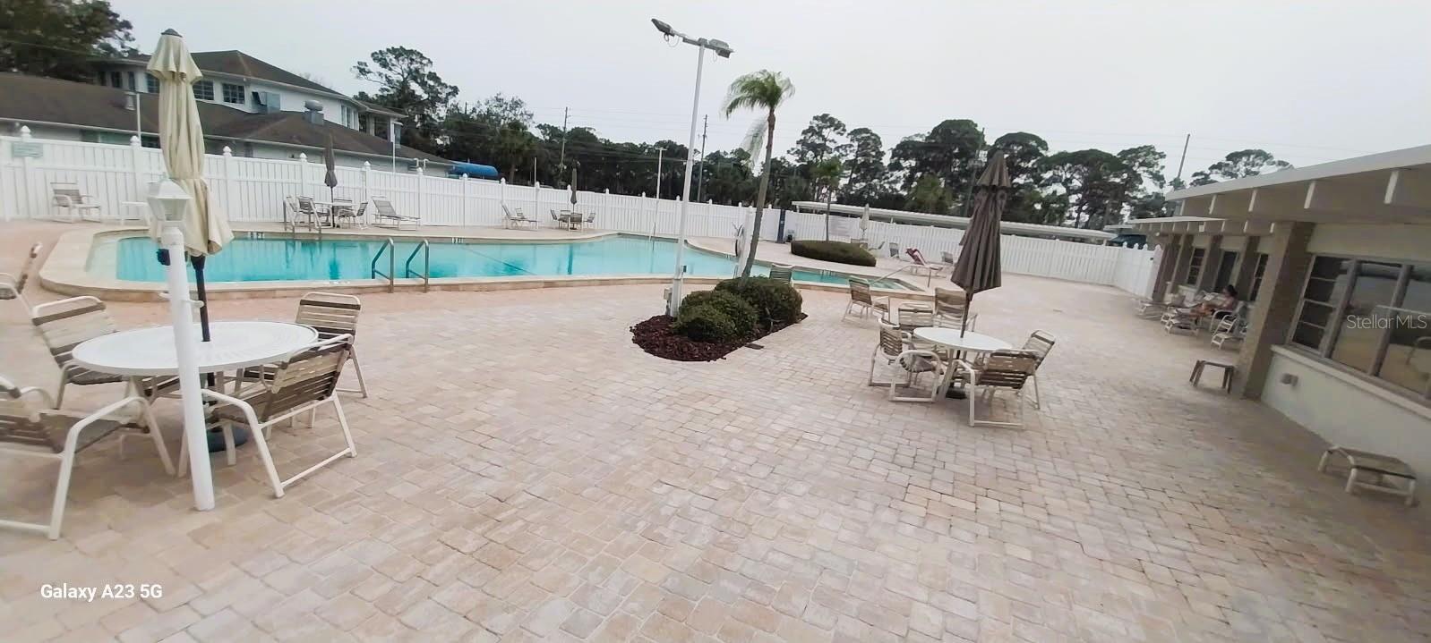 Sparkling Pool with newer pavers and patio furniture