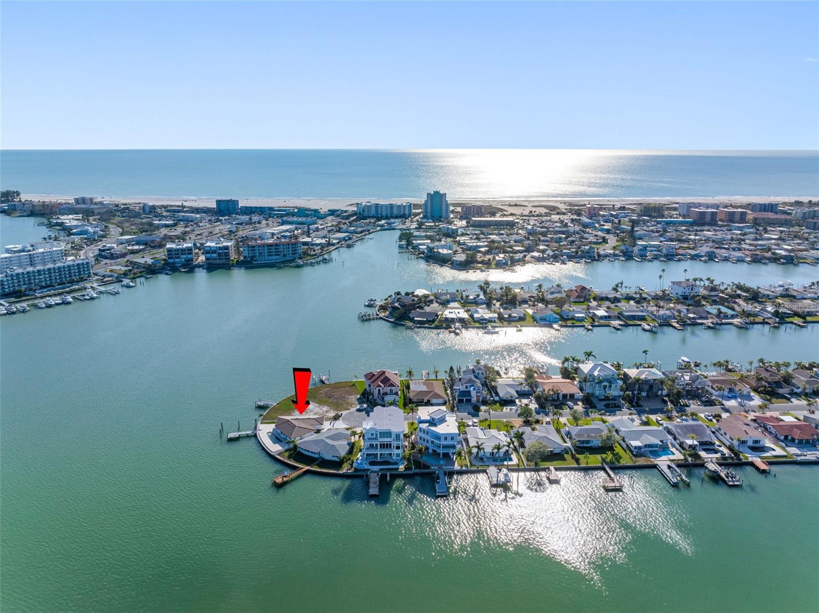 A little less than a mile to the beach, this rare point lot waterfront home has sunrise and sunset vistas every day.