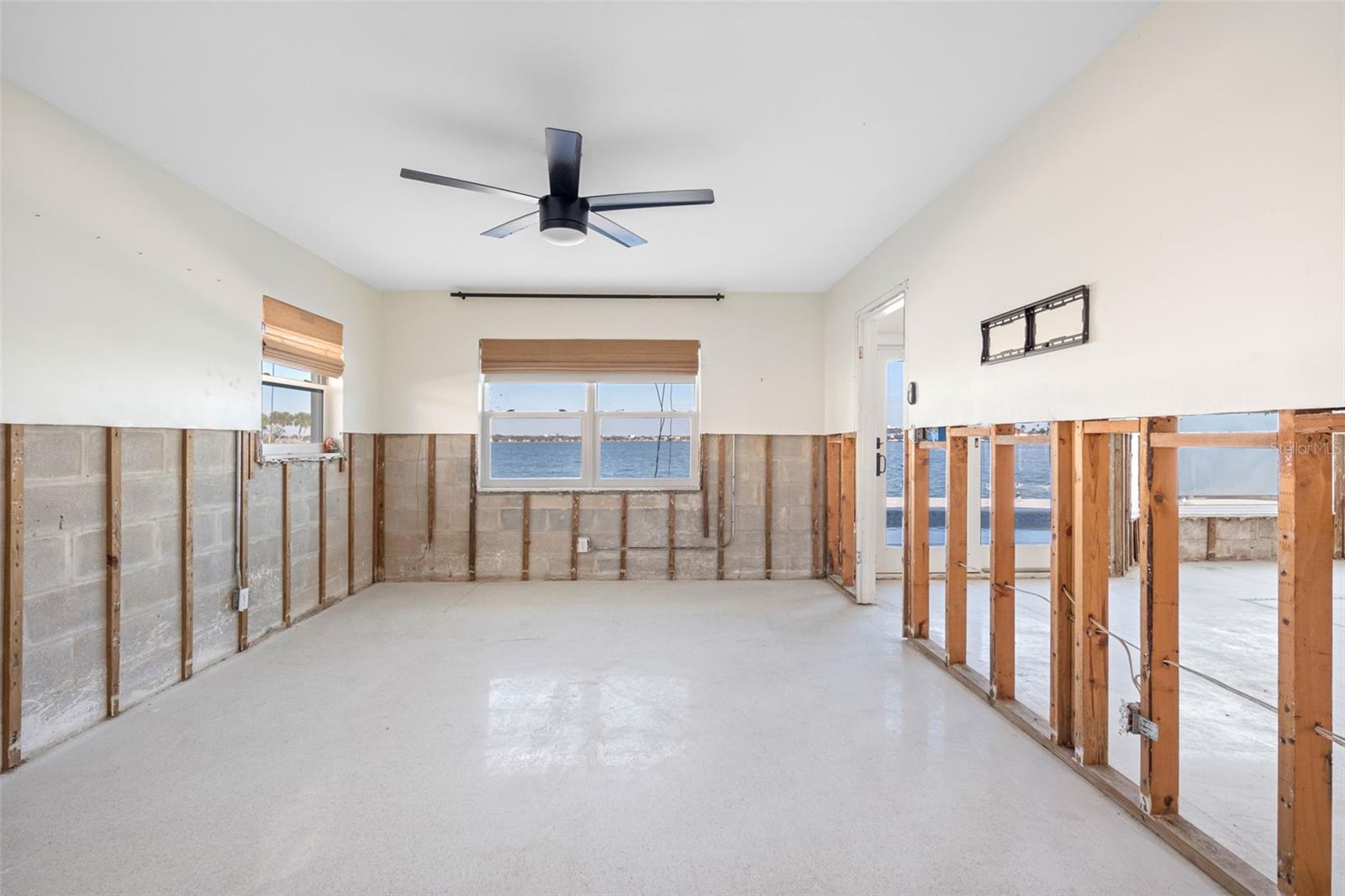 Primary bedroom with pool and water views.