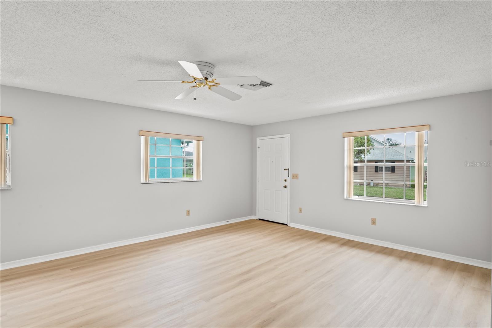 Livingroom has ceiling fan, bright and light windows, NEW interior paint!