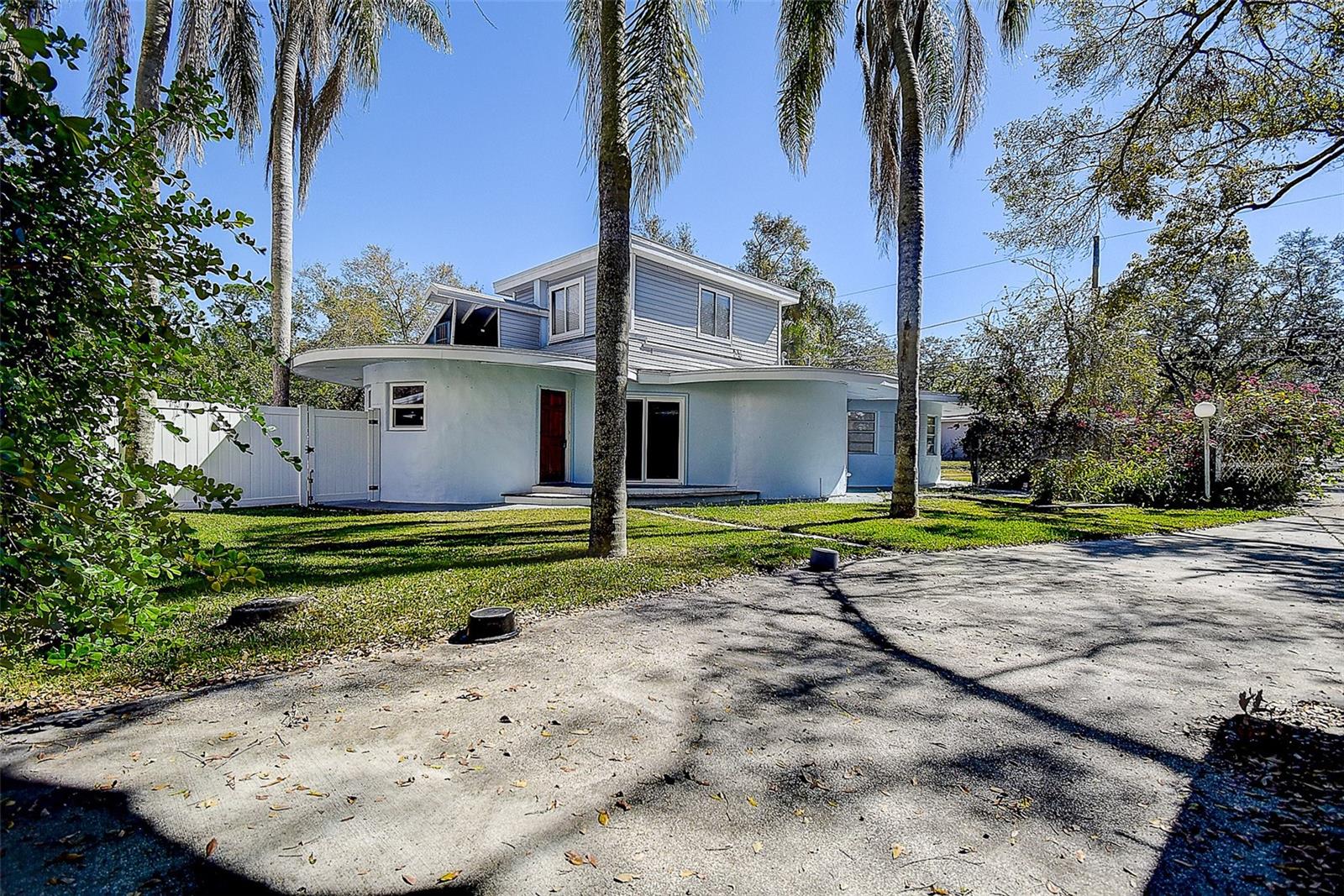 Huge driveway with garage on right and home on left